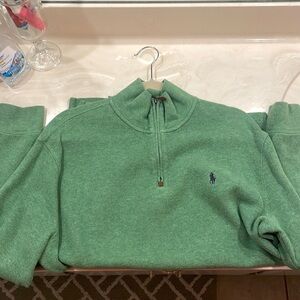 Mens Q-Zip Pullover. Green in color, with black logo.